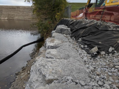 Limestone Blocks Placed on Prepared Foundation Sediment Curtain Placed in Creek