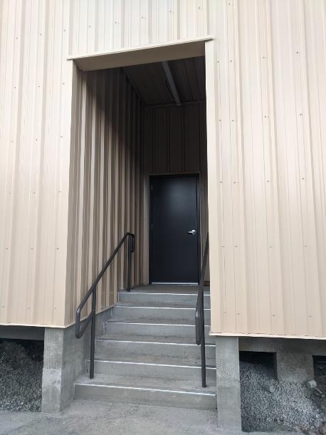 interior shot of entry way showing door, new steps and railings