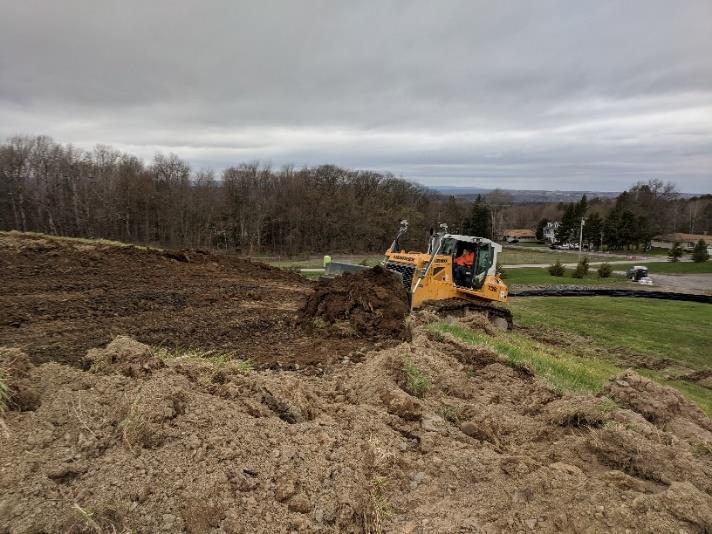 bulldozer leveling hill using erosion control fabric