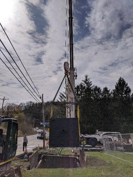  crane setting the PRV chamber in ground