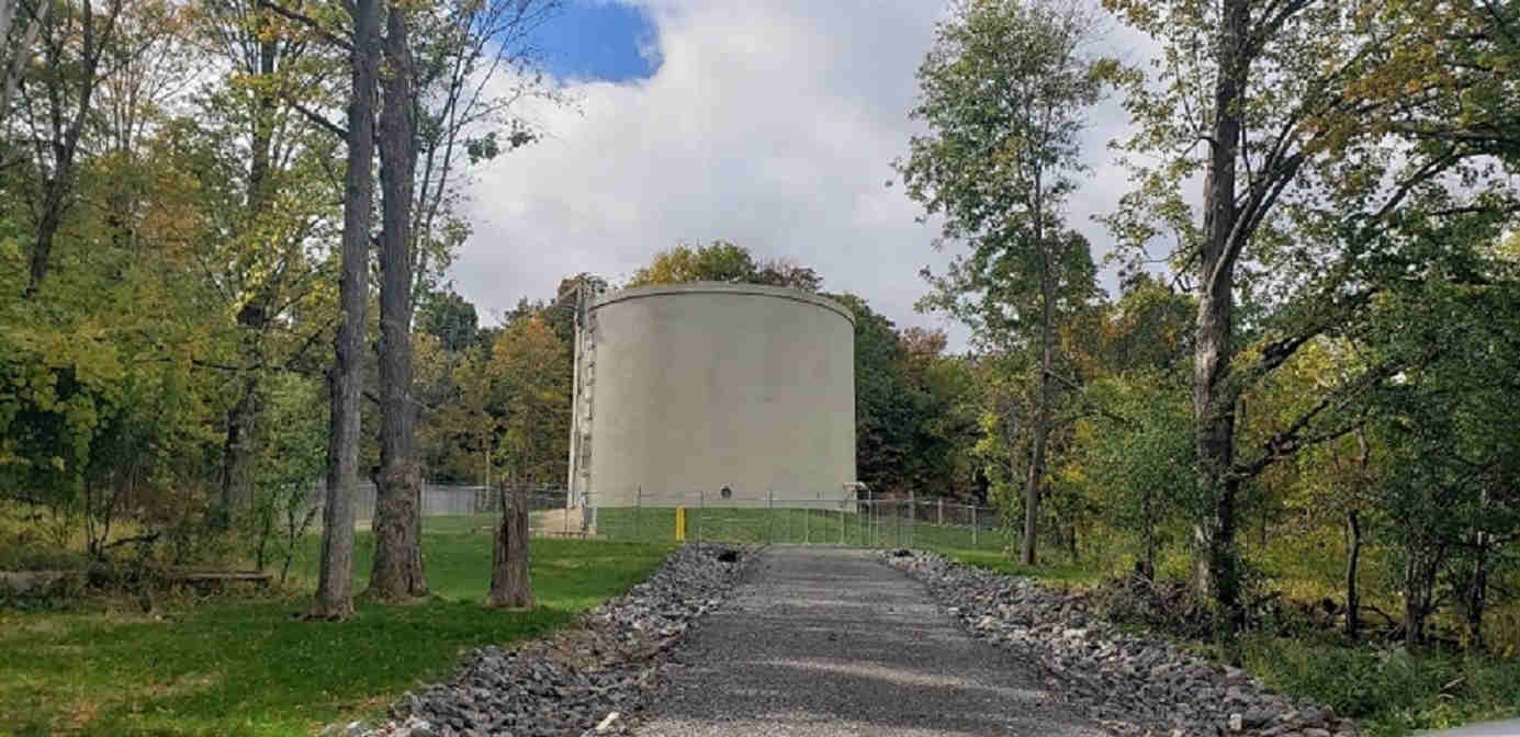 accress road showing tank and fence