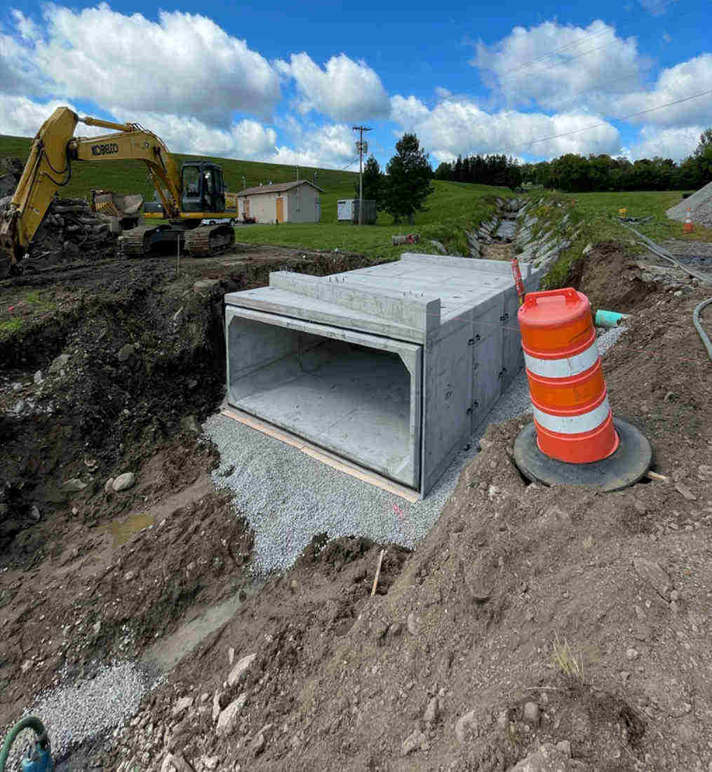 four sided concrete box over gravel and dug trench