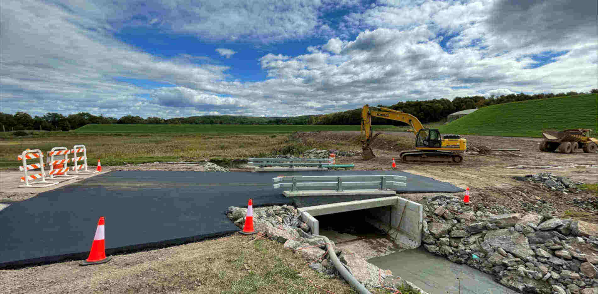 new concrete bridge paved over with guard-rails 