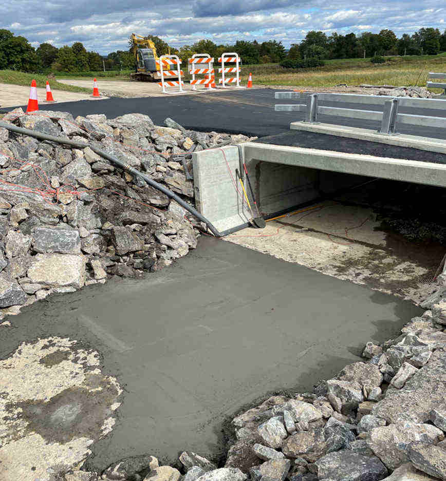 below the bridge, gound being cemented over to create water path