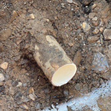 close up of drain pipe sticking out of ground