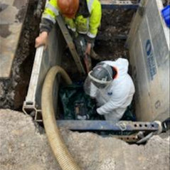 two men working in pit