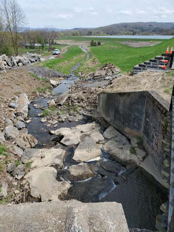 stream and rocks next to bridge