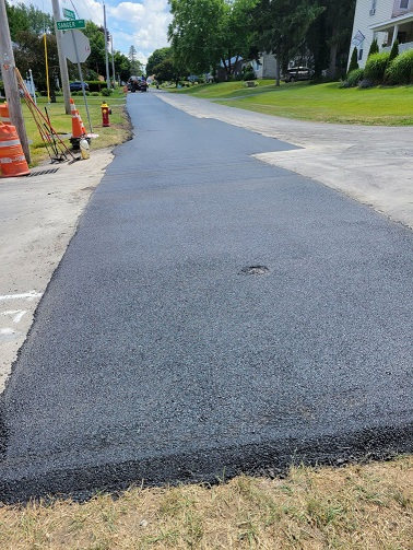 newly paved road section of pipe run area 